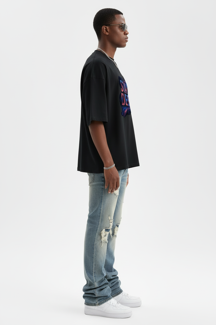 Left side view of model in Stay Deep tee