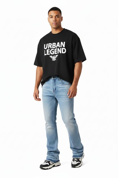 Male model wearing baggy jeans with slightly cropped designer tee
