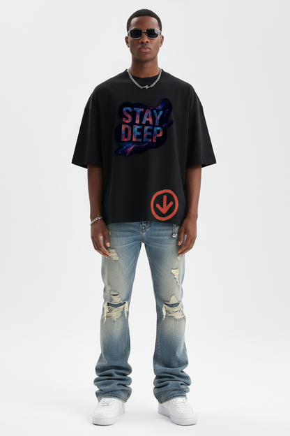 Model in Stay Deep tee with stacked jeans and AF1s