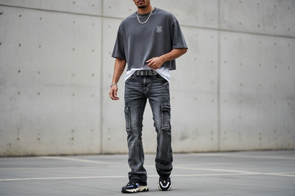 Model wearing boot cut cargo jeans in urban streetwear style