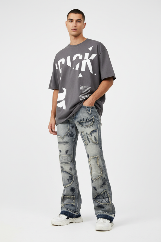 Slim model wearing wide flare distressed jeans with streetwear